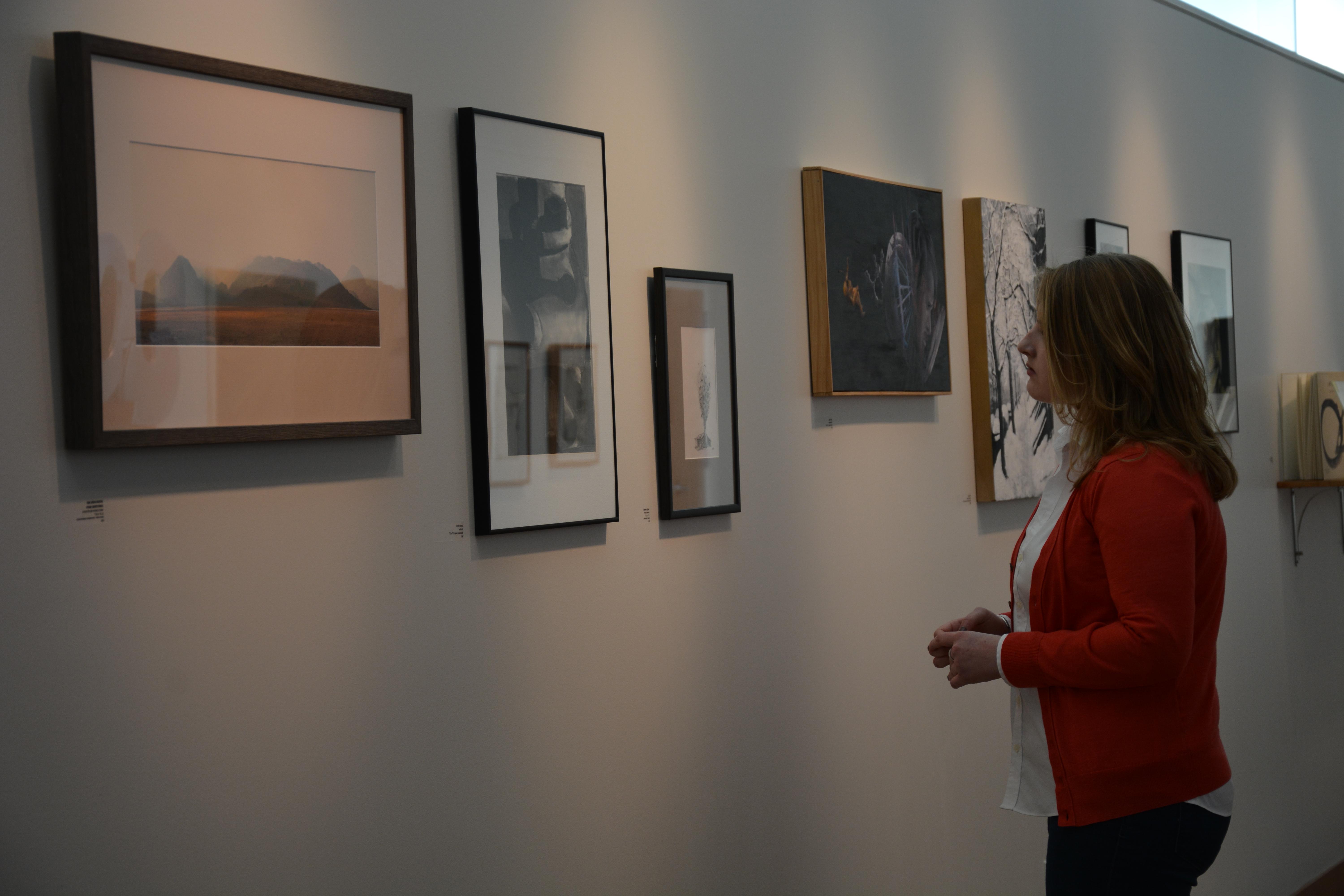 Guest looking at art exhibited in the Sally Otto Art Gallery at Mount Union